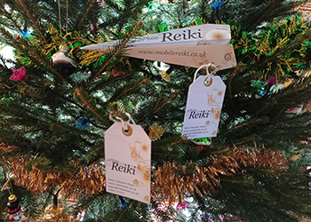 Mobile Reiki Brighton luggage tag business cards and origami aeroplane leaflet as Christmas tree decorations